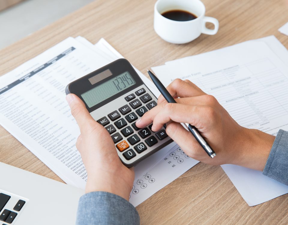 Man using calculator to count income and outcome